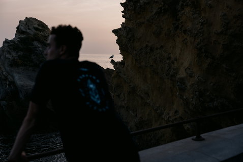 ION Bike Graphic SS men's tee in black with teal back graphic print at coastal cliffs