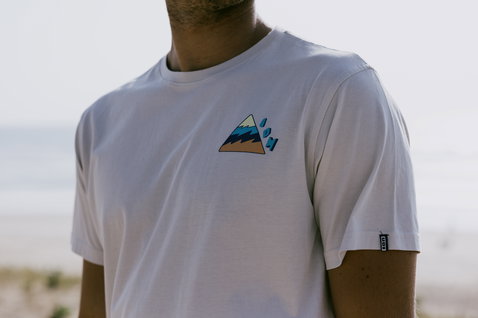 ION Bike Mood SS men's t-shirt in white with mountain chest graphic worn at the beach