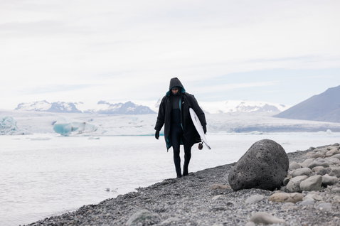 ION Storm Coat changing robe during wave surfing at a glacial lagoon in black