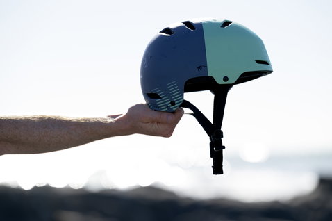 ION Slash Amp helmet in slate blue and teal side profile outdoors