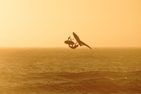 ION Slash Amp helmet during wing foiling over the ocean at golden hour