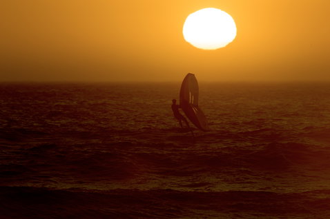 ION Slash Amp helmet during wing foiling on the ocean at sunset