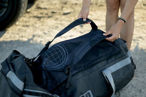ION Suspect duffel bag 90l in black being handled outdoors