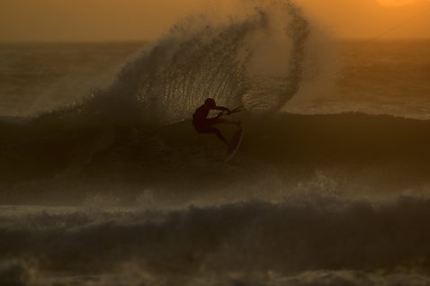 ION Seek Amp 4/3mm back-zip fullsuit during kitesurfing on the ocean at golden hour