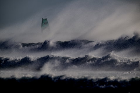 ION Element 2/2mm back-zip shorty wetsuit during kitesurfing in extreme ocean waves