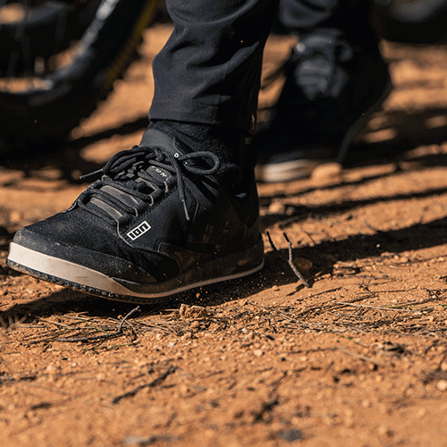 ION Scrub flat pedal bike shoes in black during mountain biking on a dirt trail