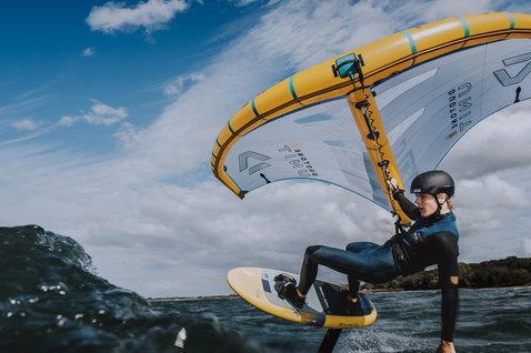 ION Arc wing waist harness in steel blue during wing foiling on the ocean