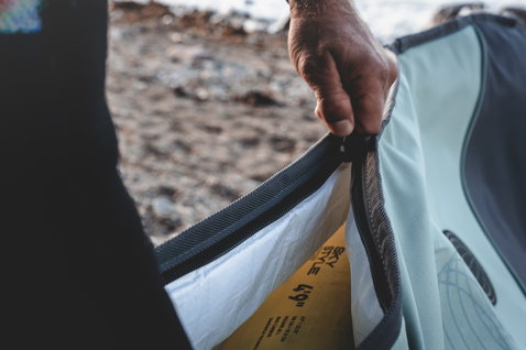 ION Wing Boardbag Core boardbag in light blue-grey with open zipper revealing off-white PE interior lining