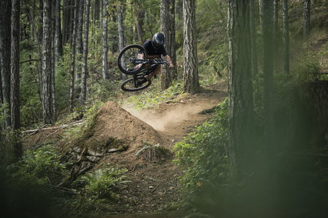 ION Bike TECH Logo cycling pants in olive black during mountain biking in the forest
