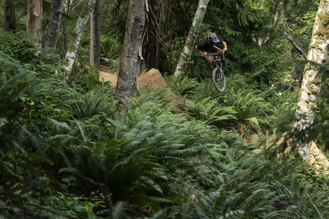 ION Bike TECH Logo cycling pants men in dark olive during mountain biking in forest
