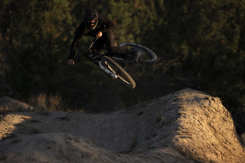 ION Bike Scrub Select MIPS fullface helmet during mountain biking on a dirt trail at golden hour