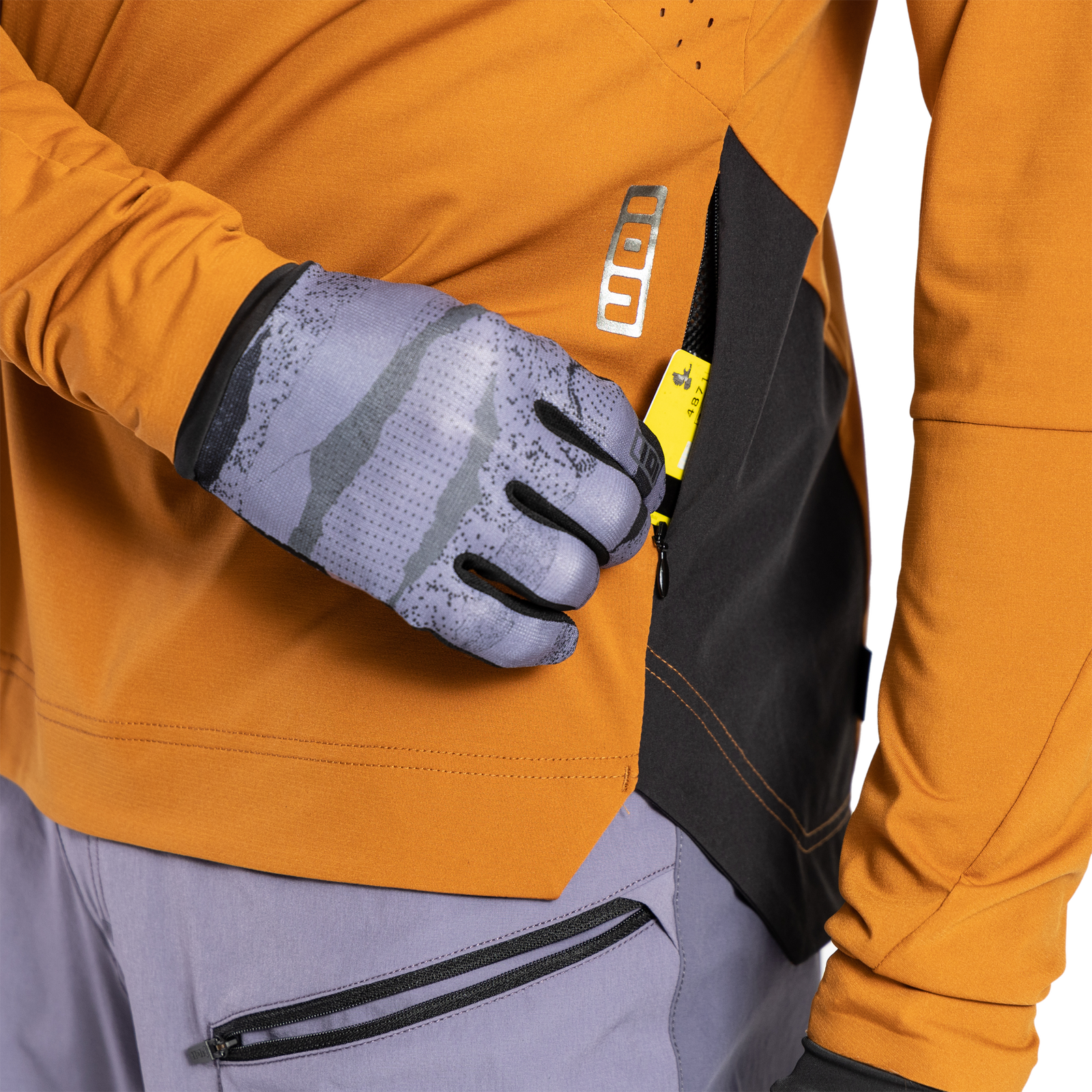 ION Scrub Amp long sleeve cycling jersey in amber orange for mountain biking, ticket port detail