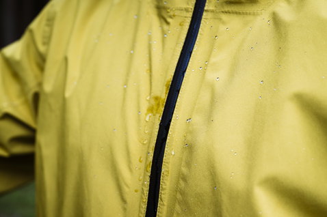 ION Shelter Lite 2.5L cycling jacket in olive yellow with DWR water-repellent finish detail