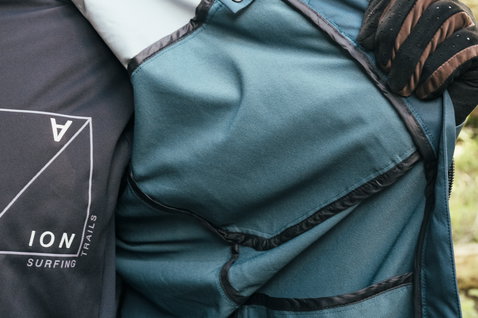 ION Shelter 3L Hybrid cycling jacket in dark teal and black interior detail with pocket for mountain biking