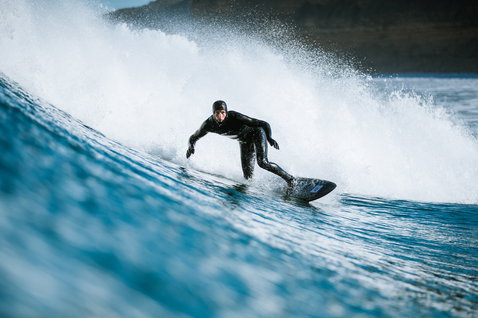 ION Ballistic Boots 3/2 Internal Split neoprene boots during wave riding in the ocean