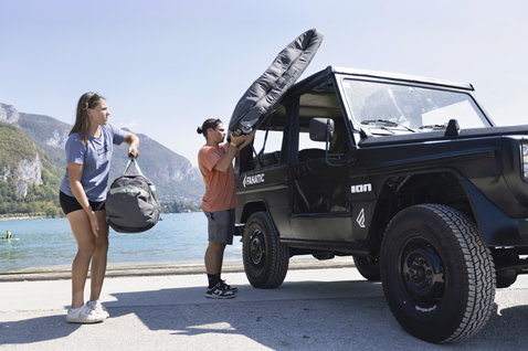 Sac de wakeboard ION Core Wheelie chargé dans un 4x4 au bord d'un lac alpin par temps ensoleillé
