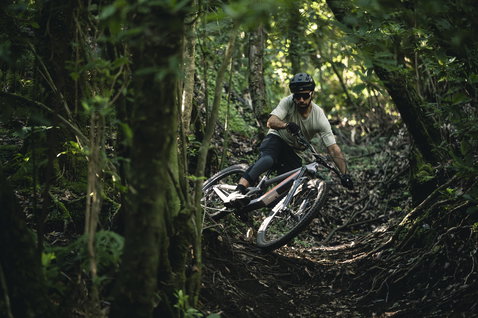 ION Bike Traze SS men's cycling jersey in sage green during mountain biking in forest trail