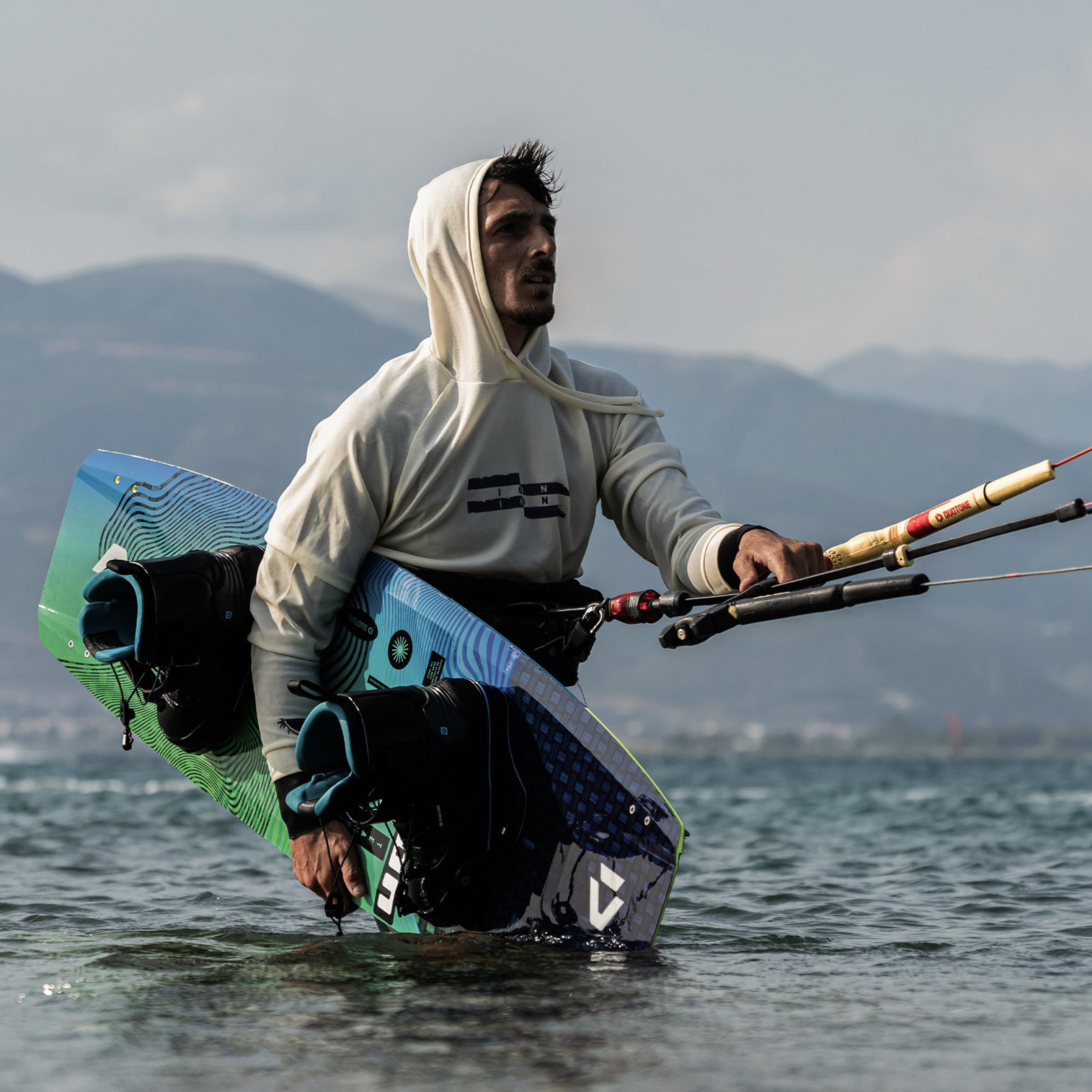 ION Wetshirt Hood LS men's long-sleeve rashguard in off-white during kitesurfing on the water