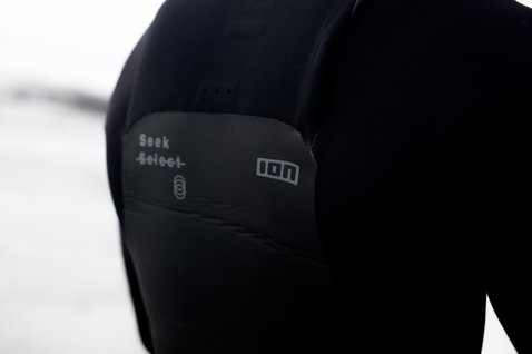 ION Seek Select 5/4mm front-zip fullsuit wetsuit in black — shoulder panel detail
