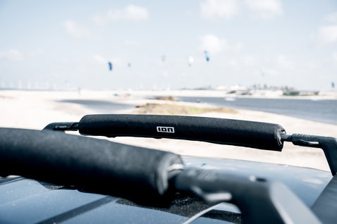 ION Roof Rack Pads 40cm in black fitted on a car roof rack at a kite beach