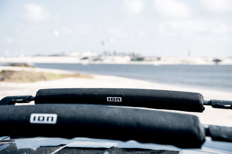 ION Roof Rack Pads 70cm in black mounted on a vehicle roof rack at the coast