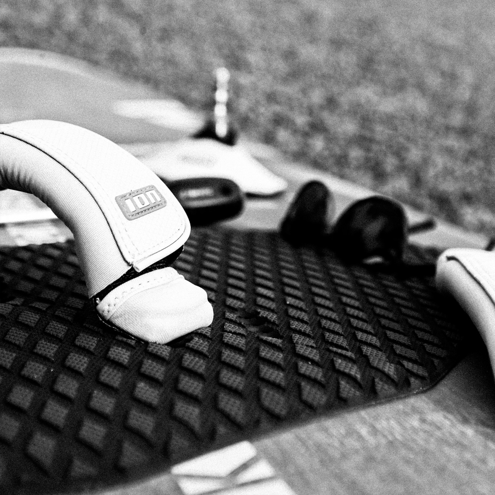 ION Water windsurf footstrap in white and black with neoprene padding on board traction pad