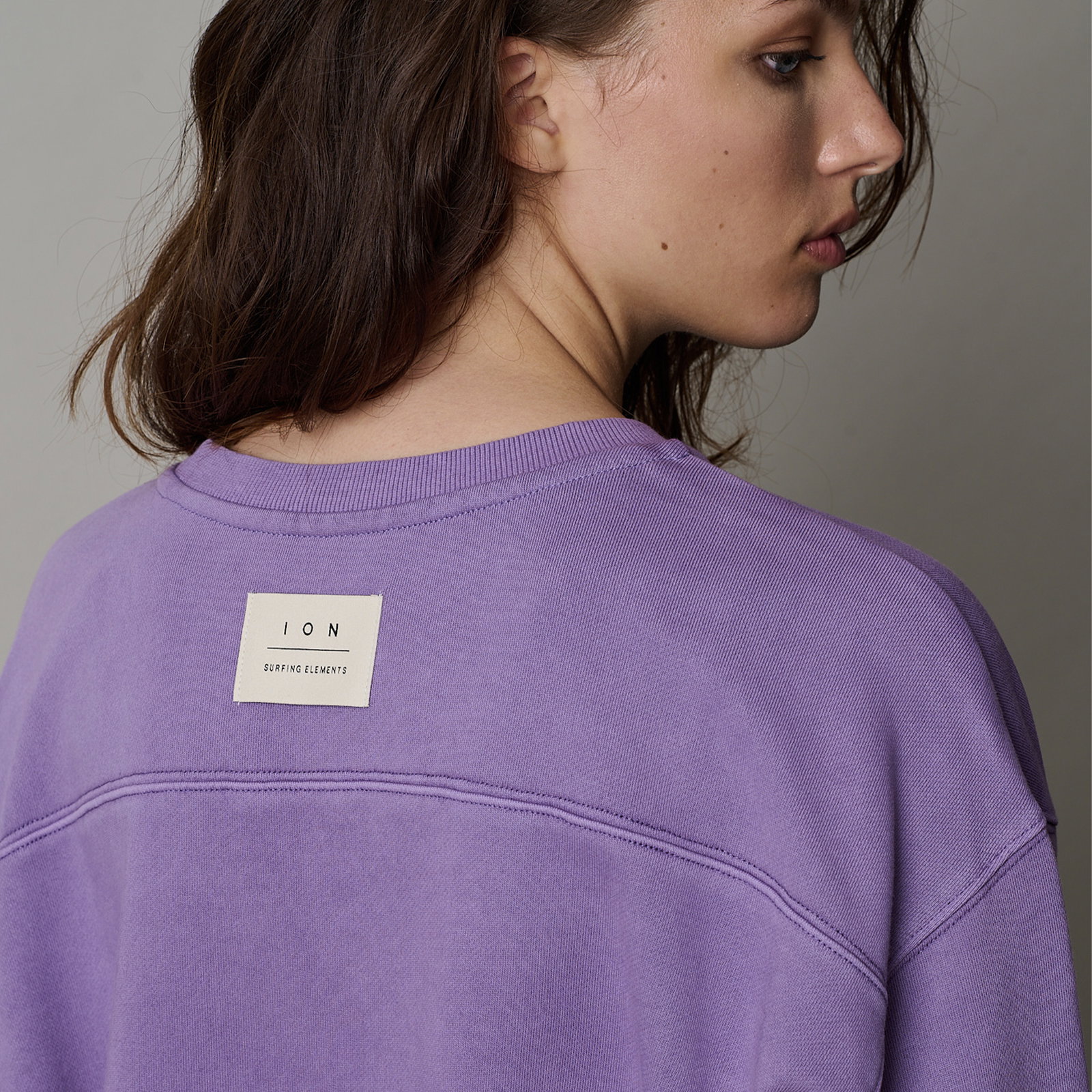 ION Mood women's sweater in lavender, back view showing ION Surfing Elements woven label