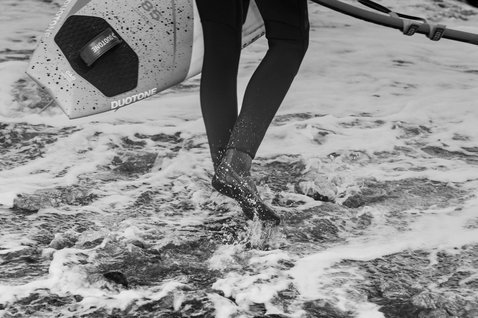 ION Plasma Boots 3/2 Round Toe neoprene boots during kitesurfing in ocean surf