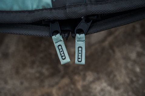 ION Core Stubby windsurf board bag zipper detail with sage green ION-branded pulls in charcoal