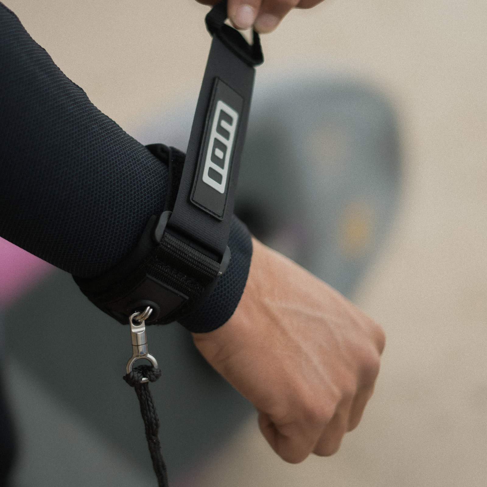 ION Core Dyneema wrist leash in black worn during wing foiling on the water