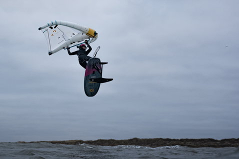 ION Amaze Amp muta neoprene 6/5mm frontzip con cappuccio durante wing foiling in costa