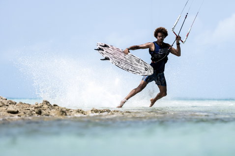 ION Basketball Shirt men's sleeveless mesh tank top during kitesurfing at a tropical rocky shoreline