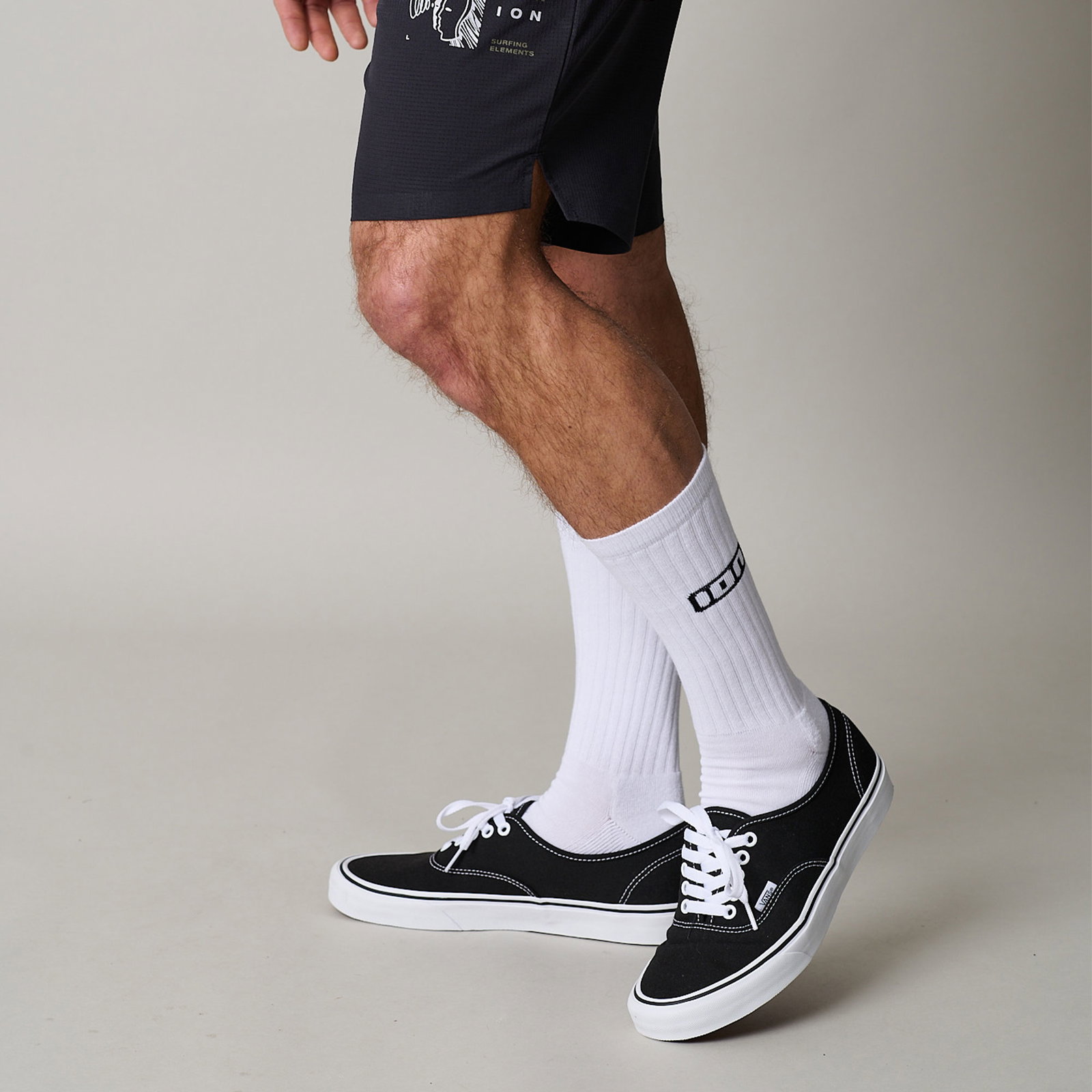 ION IONIC long socks in white, worn with black sneakers
