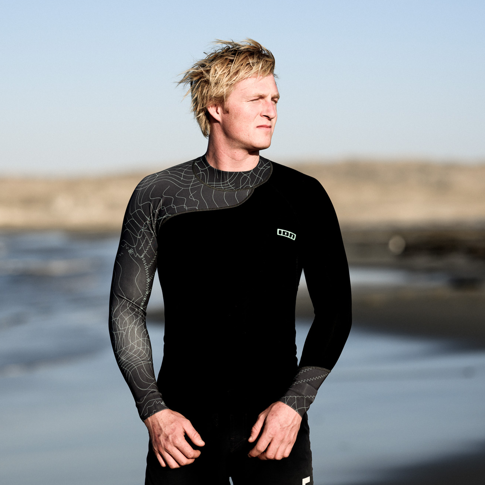 ION Neo Top 0.5 long sleeve neoprene top in black during watersports at the coast