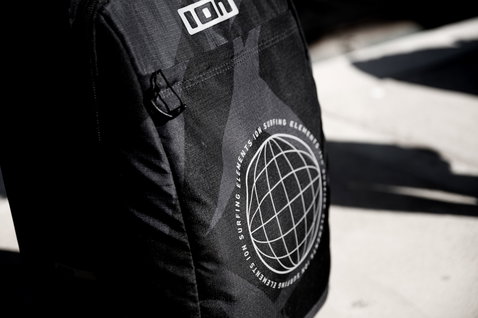 ION Carry-on Wheelie travel bag in black with ION Surfing Elements globe logo detail