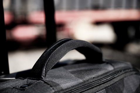 ION Carry-on Wheelie luggage bag handle and zipper detail in black