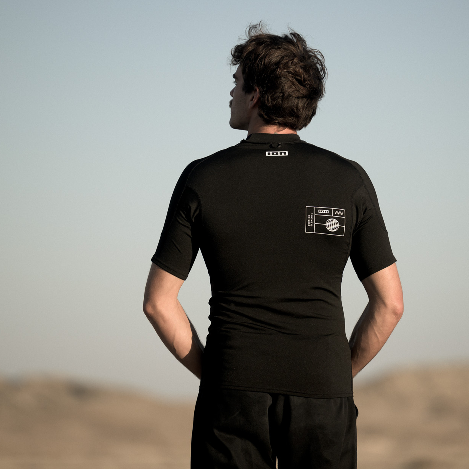 ION Thermo Top short-sleeve rashguard for men in black worn from behind