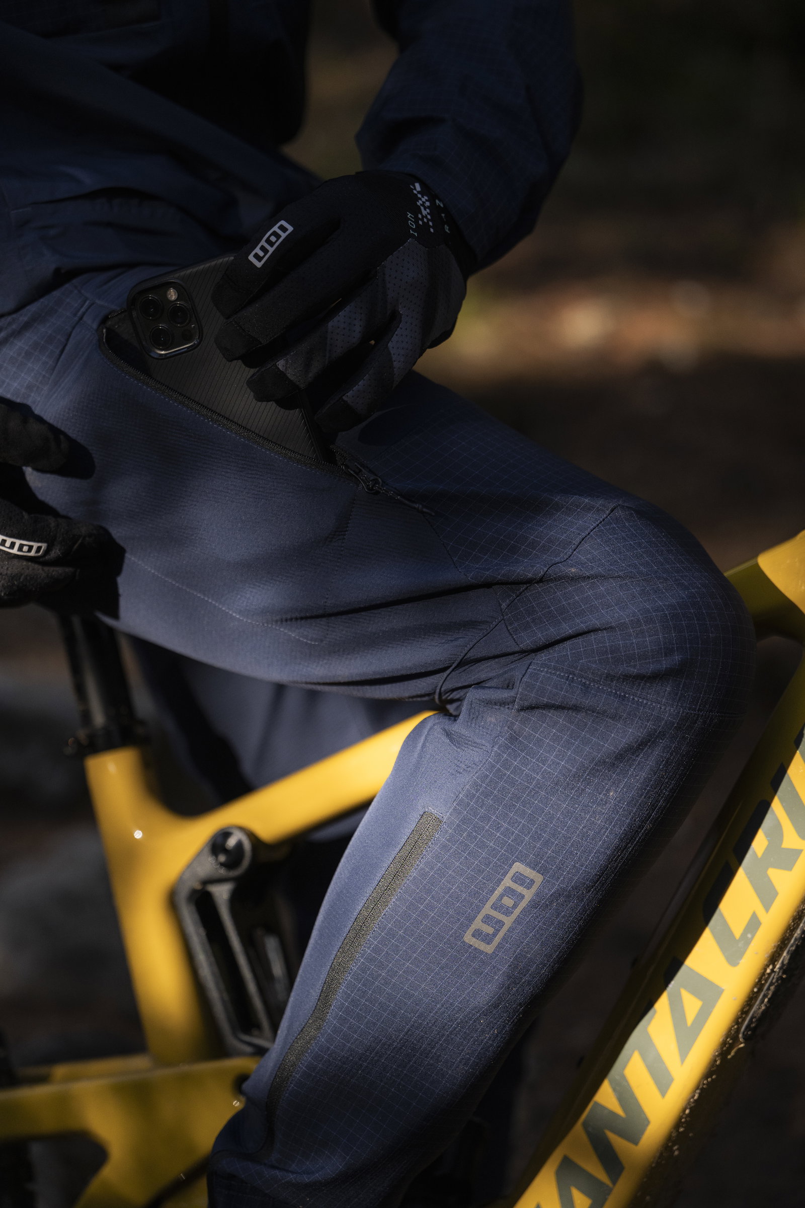 ION Shelter 2L softshell bike pants men during mountain biking in forest in midnight navy