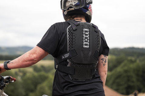 ION Bike ARCON HD Pro chest and back protector in black during mountain biking on a hillside trail
