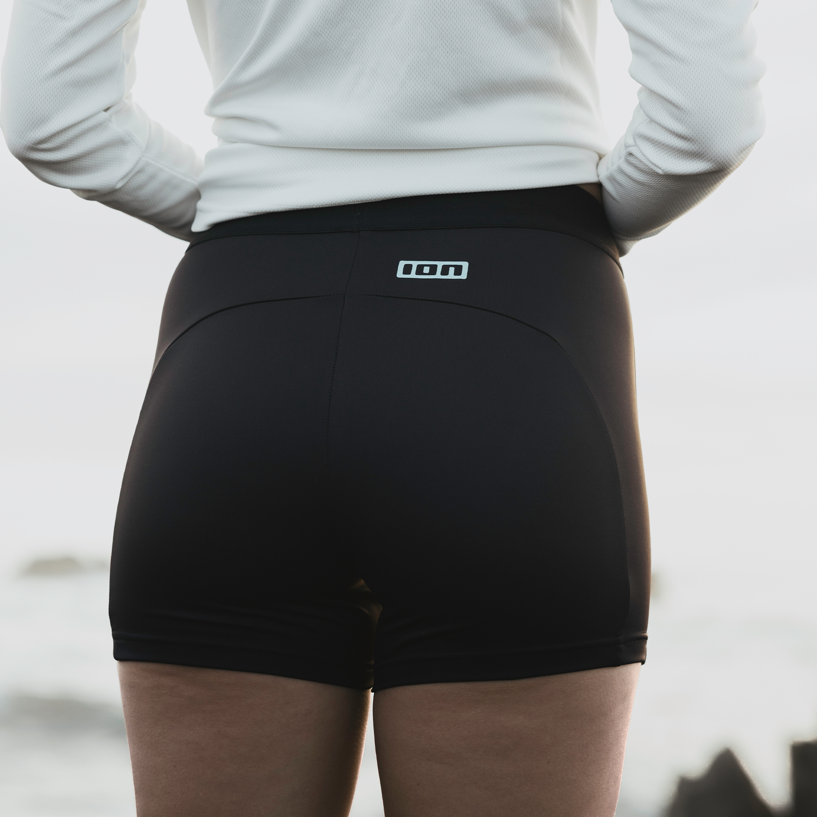 ION Bottom Rashguard Shorts women in black during watersports at the coast