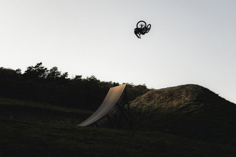 ION Bike Scrub Amp BAT long sleeve jersey during freeride mountain biking at a bike park jump