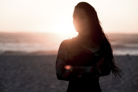 ION Amaze Core 3/2mm front-zip fullsuit wetsuit in black during kitesurfing at the beach at golden hour