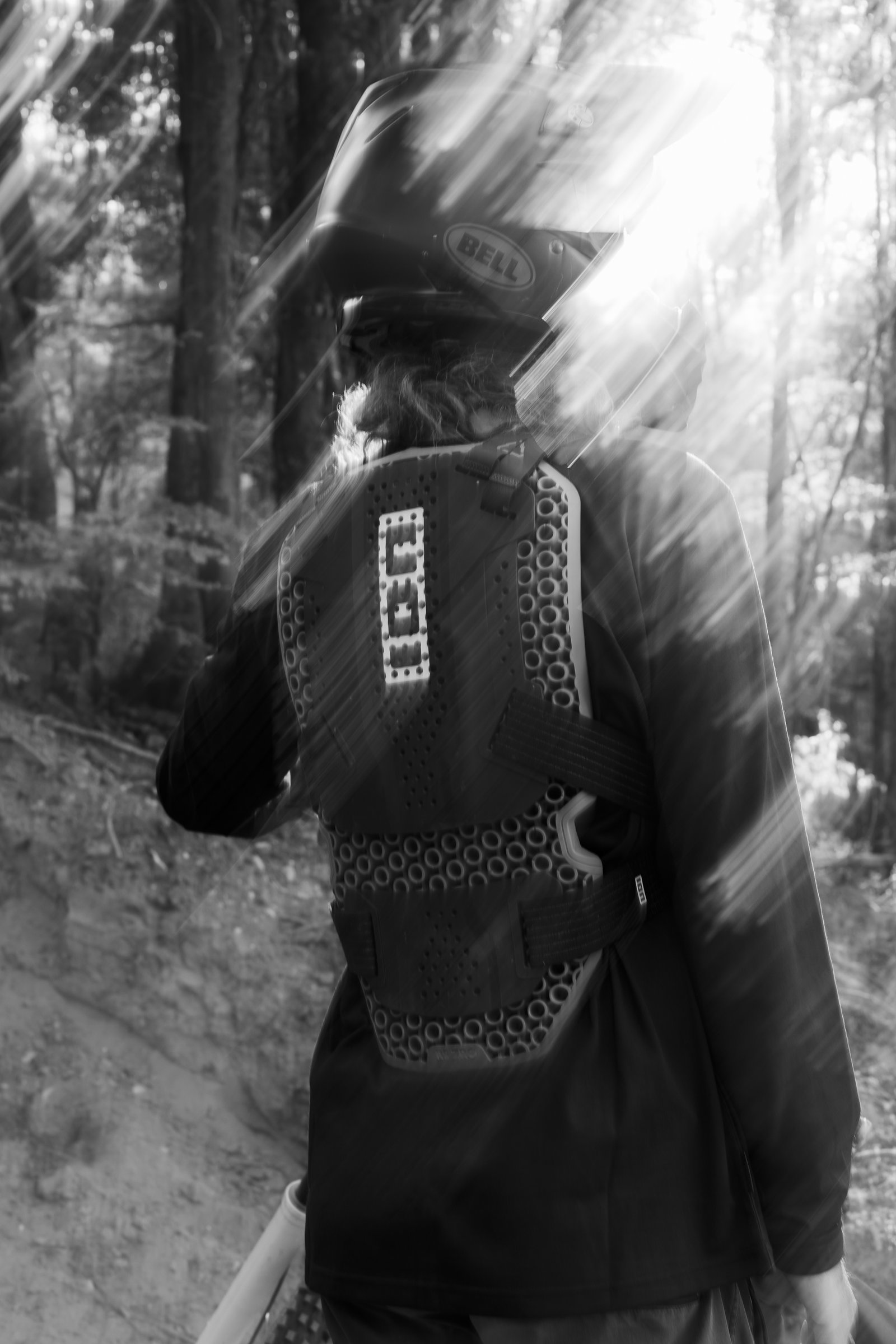 ION ARCON HD Pro chest and back protector in black during freeride mountain biking in forest