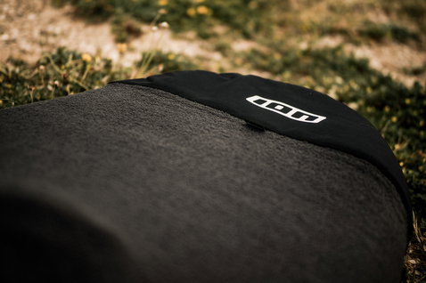 ION Wing Sock board cover 5'5" in charcoal black, detail view showing ION logo and fleece texture