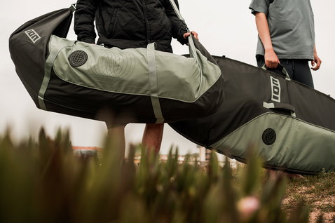 ION Wing Boardbag Core wing boardbag in black and sage green carried along a coastal path