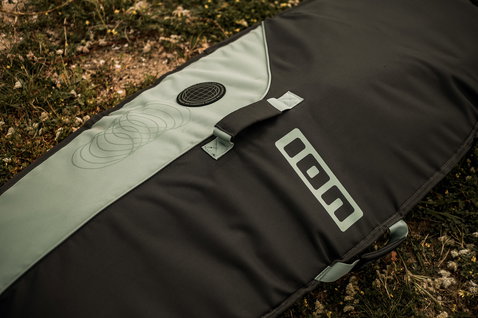 ION Wing Boardbag Core wing foil boardbag in charcoal black and sage green outdoors