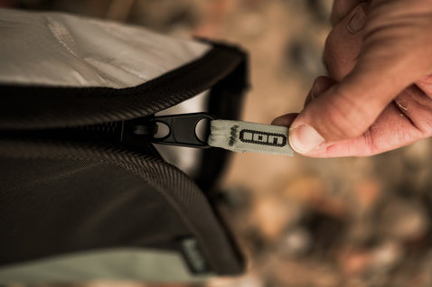 ION Wing Boardbag Core Slim zipper detail with ION logo pull tab in sandy beige and black