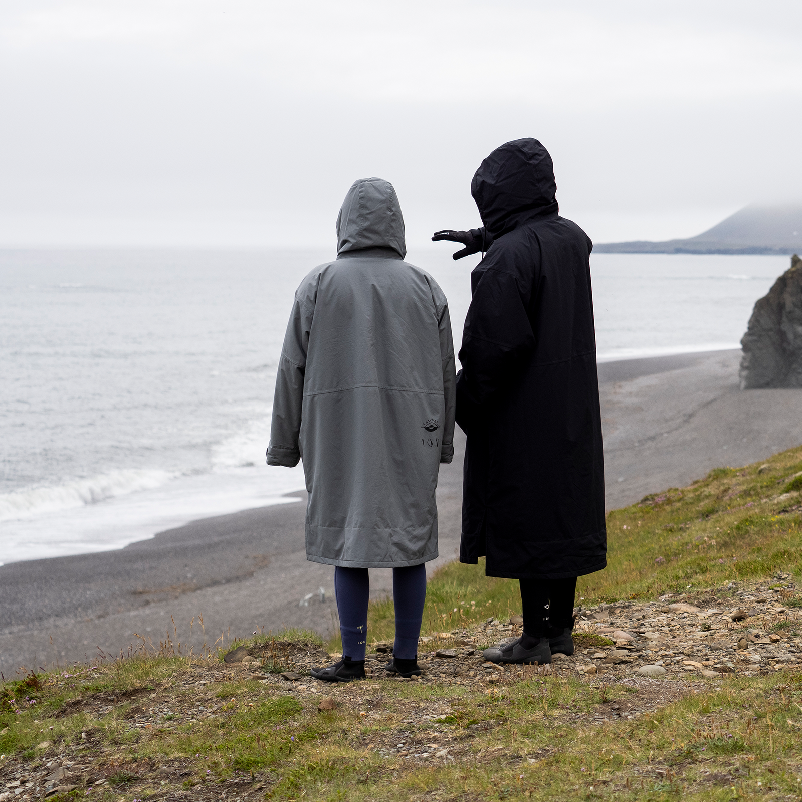 ION Water Storm Coat unisex jacket worn at the coast in grey and black