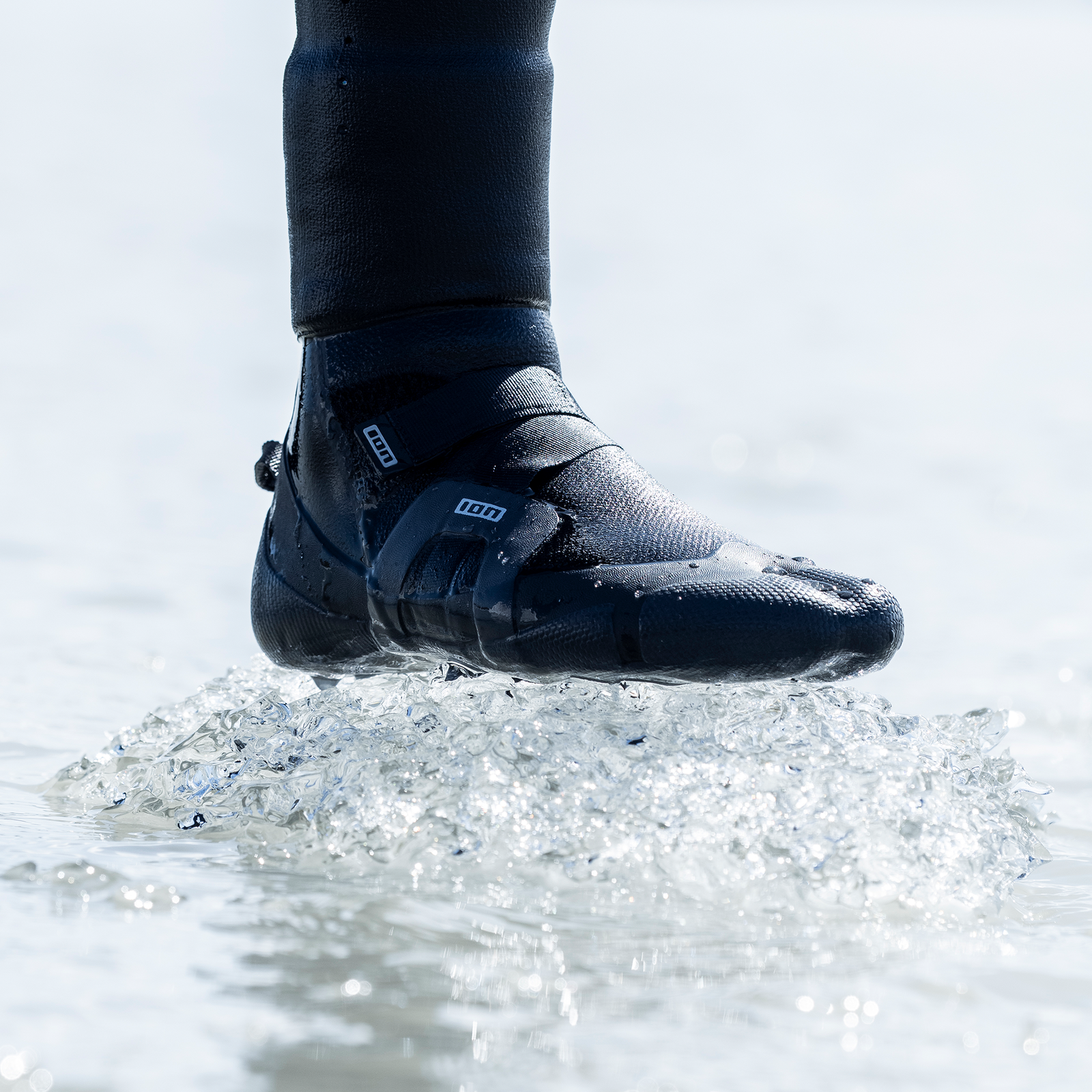ION Ballistic neoprene boots 6/5mm split toe in black during kitesurfing in water