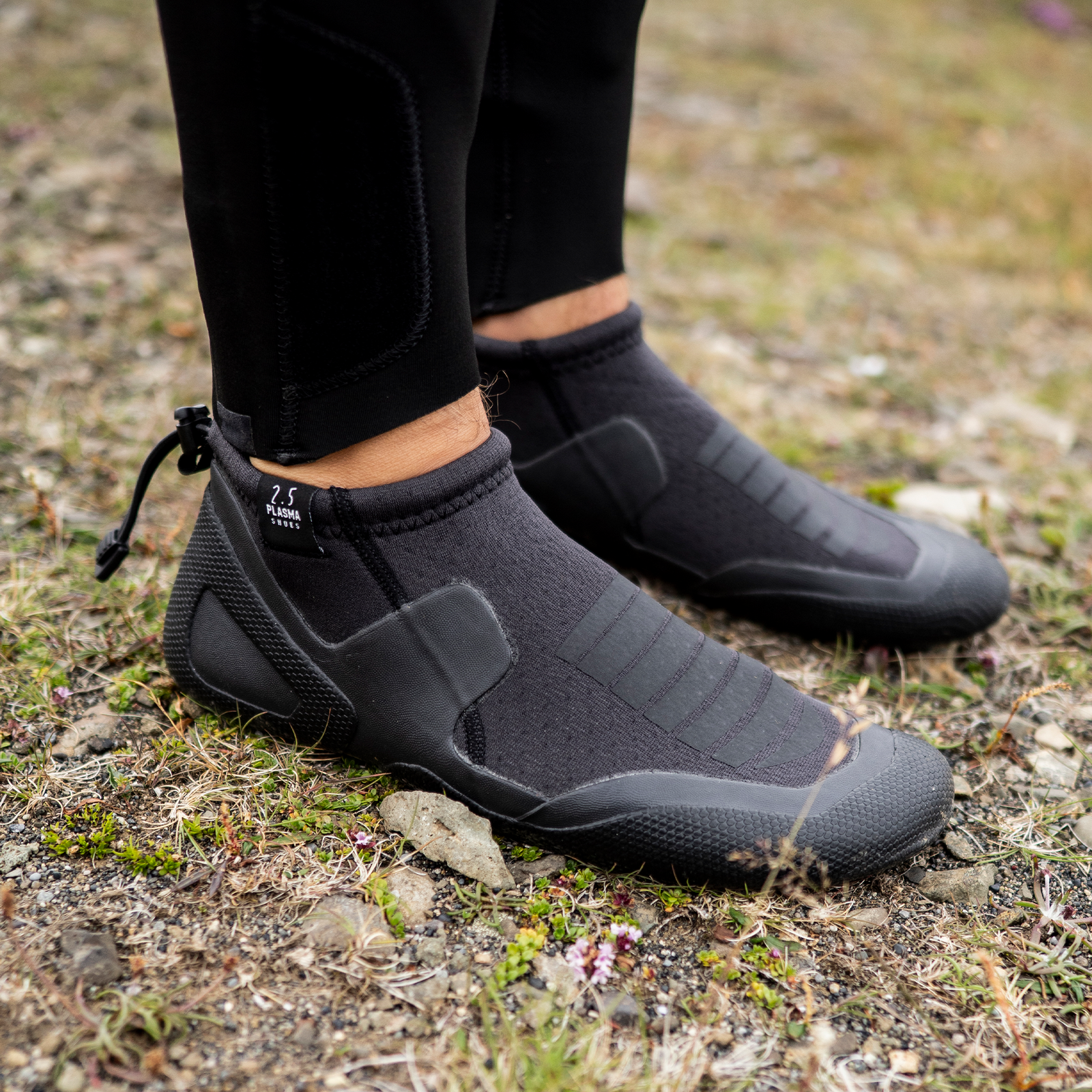 ION Plasma Shoes 2.5 Round Toe neoprene boots 2.5mm in charcoal black worn outdoors